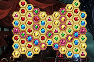 Šareni heksagonalni dragulji poređani u obliku srca na tamnoj pozadini