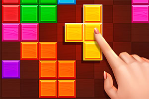 Prst koji dodiruje žuti Tetris blok na digitalnom ekranu sa šarenim kockama